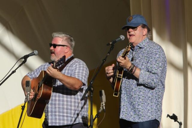 The twang of a mandolin and banjo; The warmth of the June sun; The smell of grilling sausages and freshly popped kettle corn. Roseburg's Stewart Park came alive on Tuesday with these sensations and more as Music on the Half Shell kicked off its 2026 free concert series.

The opening performance featured the John Jorgenson Bluegrass Band, also known as J2B2. Featuring instrumentalists Mark Fain, Herb Pedersen, Patrick Sauber and the titular Jorgensen, the band performed a lineup of folk-rock influenced bluegrass that blended new and traditional sounds.

Jorgenson said the band hoped to provide the audience with a chill, laid-back experience where they can forget about the weight of the world and enjoy no-frills musicianship.

"We want to let them forget about all of the political stuff and the financial stuff and all the stuff that's challenging and just chill out and listen to the music, get lost a little bit," Jorgenson said. "It's not tapes. It's not visuals. It's not dancers. It's not anything except people with actual instruments singing and playing. It's very real."

For More Information Please Visit www.nrtoday.com