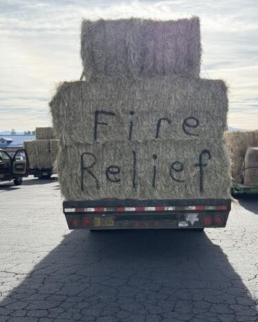 A bumper crop of grass hay in Douglas County is benefitting ranchers and livestock who have been severely impacted by wildfires in Southeastern Oregon’s Harney County.

A recent volunteer and donation effort resulted in an estimated 100 tons of grass hay being hauled over the Cascade Mountains to Burns where it was distributed to cattle, sheep and horses whose grazing grounds have been burned. Cases of bottled water and sacks of feed were also donated.

Money donations were accepted to help with fuel costs although some of the drivers turned down that offer, resulting in $3,400 being left in Burns to be used as needed.

“It’s pretty incredible what the people from Douglas County have done for us,” said Nicole Adamson, president of the Harney County Cattlewomen’s Association. “Our livestock just needed the food.”

Seven fires that started in late July and have burned through August in Harney County have destroyed hay stacks, barns, grazing grounds and cow camp cabins. It’s anticipated some cattle will be found dead and others severely injured by the fire and smoke.

Drew Fairbairn, an Umpqua area rancher, pitched the donation idea on Facebook and within a few days, the donations and transportation were organized for the trip east.

“I remember the Texas-Oklahoma fire a couple years ago and seeing a convoy to help those ranchers,” Fairbairn said. “There was nothing I could do then to help, but when these fires happened here, God tugged at my heart to respond.

“I had a good hay year and I know others did too so I put it out on Facebook and the whole community here came out of the woodwork to help,” he added. “Once the ball got rolling, there was lots of help.”

A total of about 50 ranches, businesses and individuals stepped up to support the Douglas County effort. Within a few days of the Facebook post, 17 truck-and-trailer rigs made the trip to Burns on Aug. 1.

For More Information Please Visit www.nrtoday.com